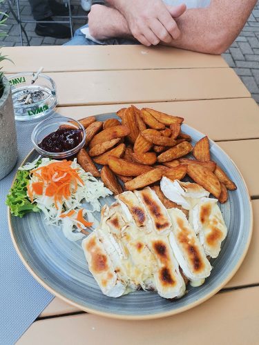 Schweineschnitzel with camembert, salad and potatoes